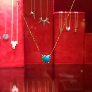 A petite heart pendant necklace in turquoise adds a touch of sparkle to the neck with geometric, glittery appeal. Shop at www.PhoenixRoze.com